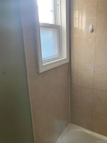 a bathroom with a glass shower door