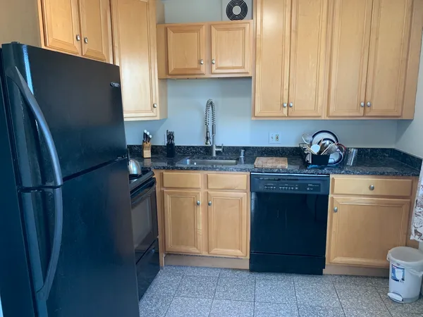 a kitchen with stainless steel appliances granite countertop a refrigerator sink and cabinets