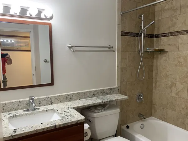 a bathroom with a sink toilet and shower