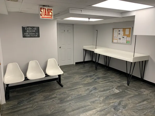a room with table chairs and wooden floor
