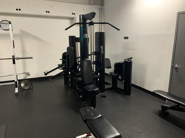 a room with gym equipment and a view of living room