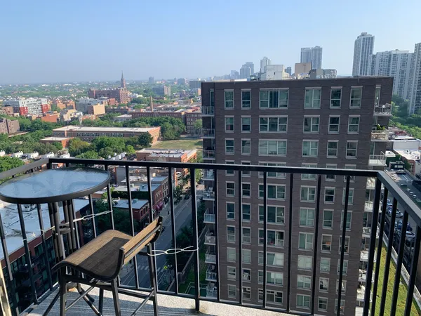 a view of a balcony with a table and chairs