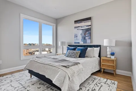 a bedroom with bed and window