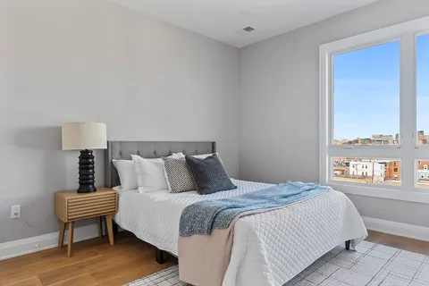 a bedroom with a bed and a night stand