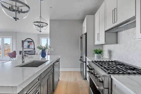 a kitchen with cabinets counter top space and stainless steel appliances