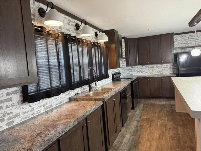 a kitchen with cabinets and wooden floor