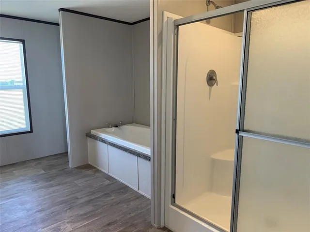 a bathroom with a granite countertop sink a toilet a mirror and bathtub