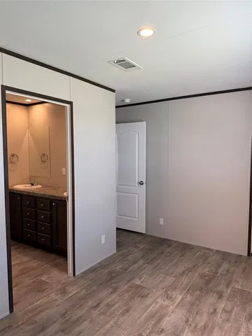 a bathroom with a granite countertop sink a toilet and a mirror
