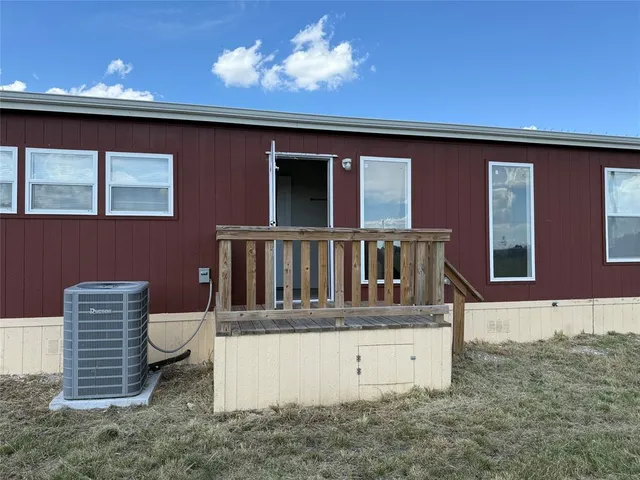 a view of a chair and table in the backyard