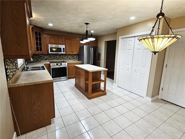 a kitchen that has a lot of cabinets in it and appliances
