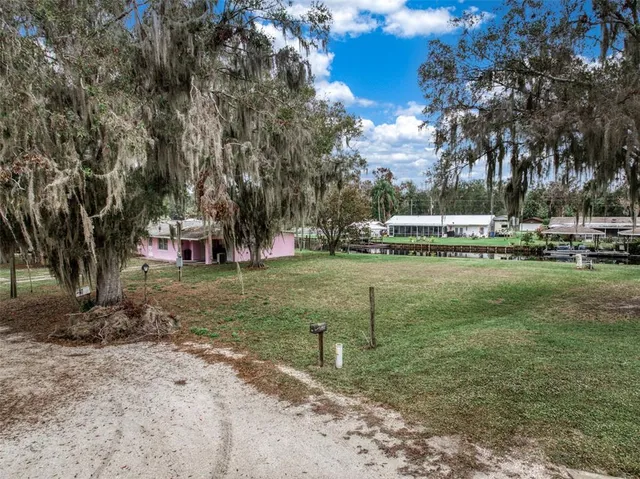 a view of a house with a backyard