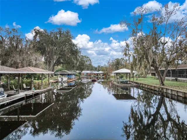 a view of pool with outdoor seating and lake