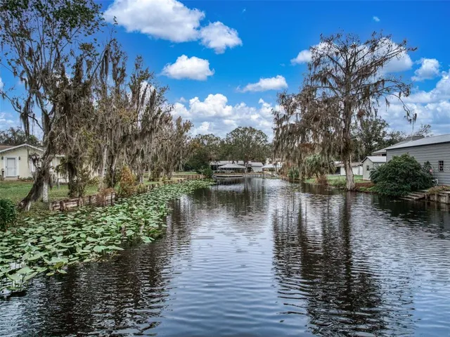 a view of a lake with houses in the back