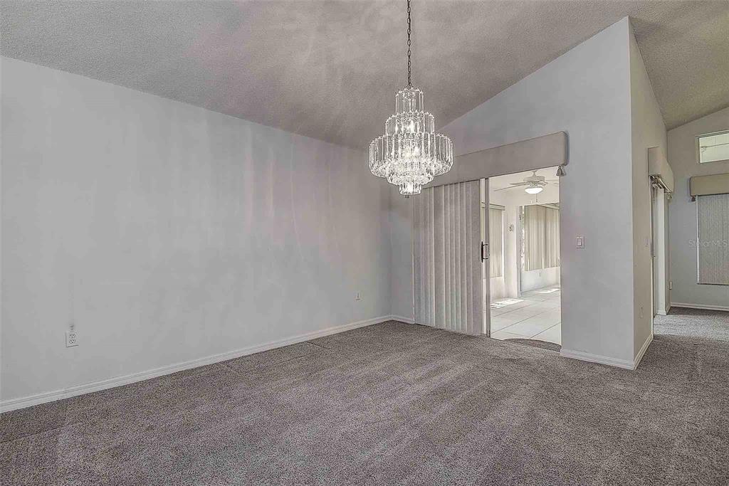 1020 Trafalgar Drive New Port Richey, FL 34655 - Photo 13 of 41 a view of a chandelier in big room and chandelier