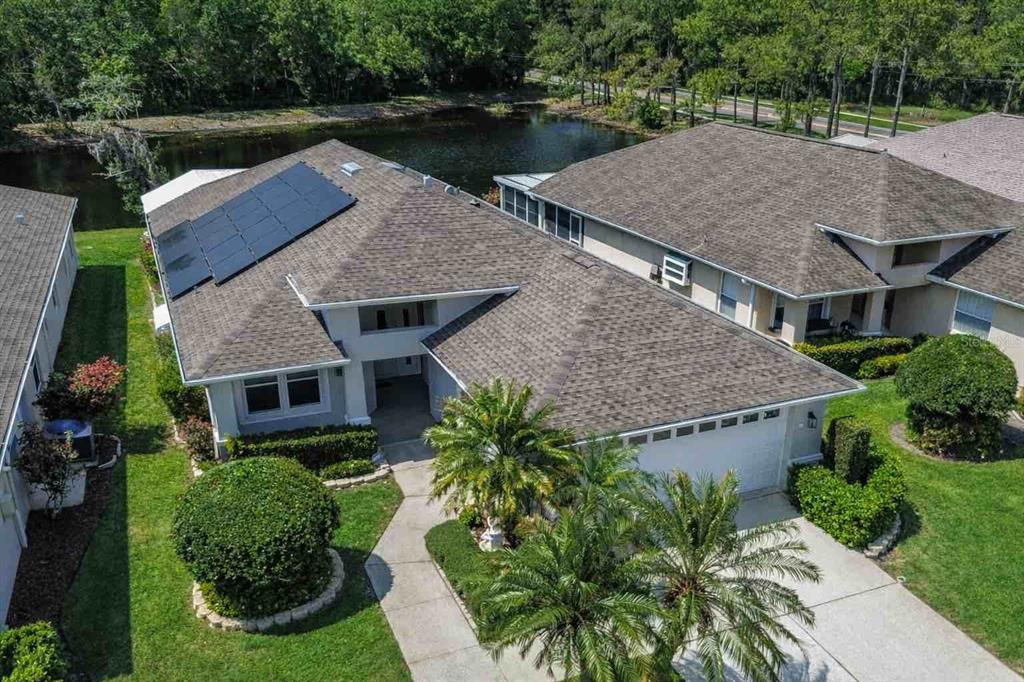 1020 Trafalgar Drive New Port Richey, FL 34655 - Photo 2 of 41 an aerial view of a house with swimming pool and garden