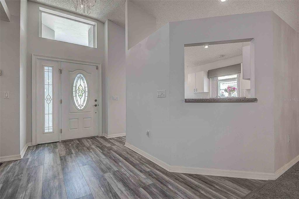 1020 Trafalgar Drive New Port Richey, FL 34655 - Photo 5 of 41 a view of a room with wooden floor and mirror