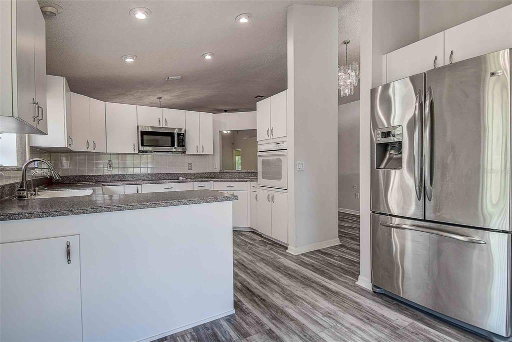 1020 Trafalgar Drive New Port Richey, FL 34655 - Photo 9 of 41 a kitchen with stainless steel appliances a refrigerator sink and microwave