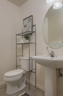 a bathroom with a sink toilet and mirror