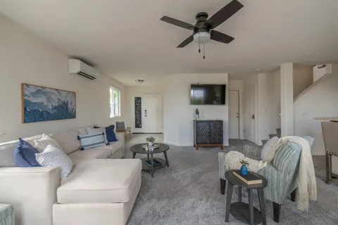 a living room with furniture a fireplace and a flat screen tv
