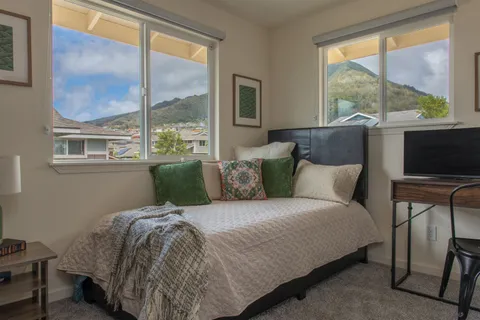 a bedroom with a large bed and a window