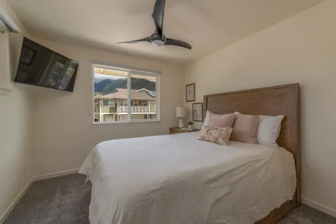a large bed sitting in a bedroom next to a window