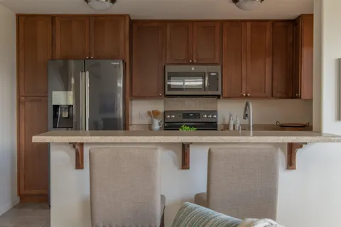 a kitchen with appliances a sink and cabinets