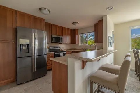 a kitchen with stainless steel appliances granite countertop a refrigerator stove microwave and sink