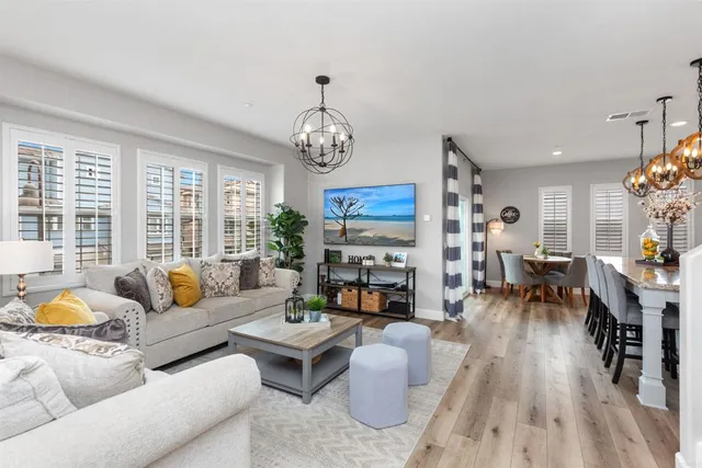 a living room with furniture fireplace and a large window