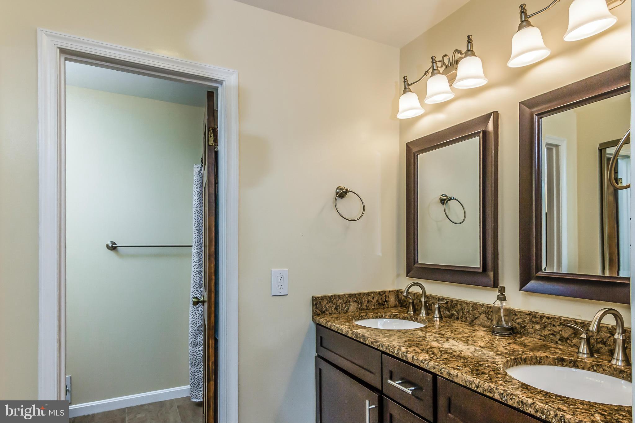 131 Summit Hall Road Gaithersburg, MD 20877 - Photo 14 of 30 a bathroom with a granite countertop sink and a mirror