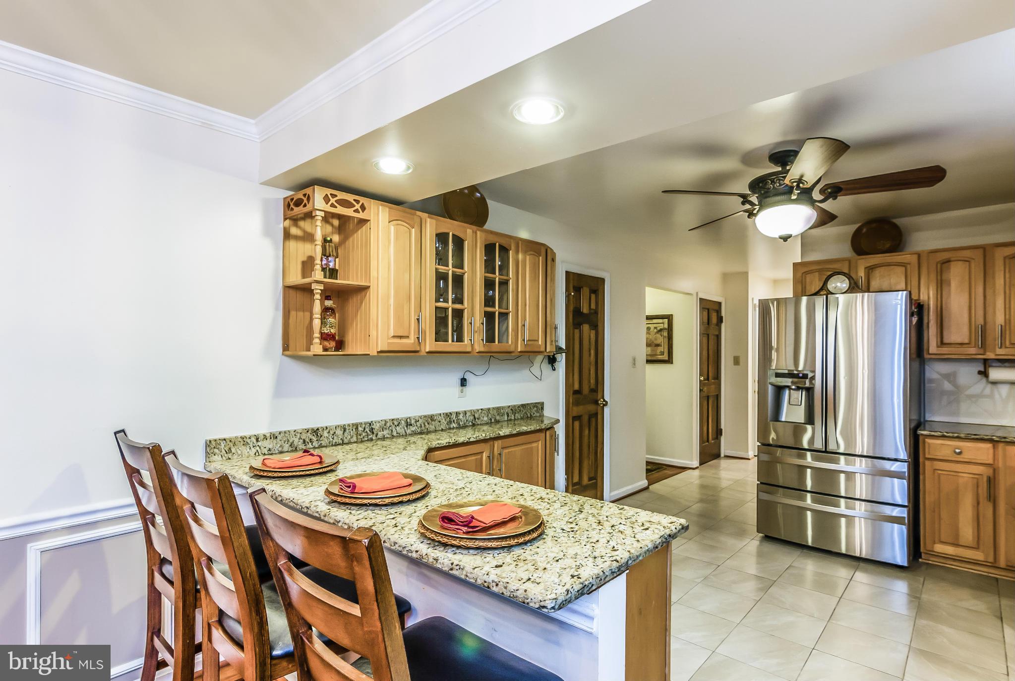 131 Summit Hall Road Gaithersburg, MD 20877 - Photo 8 of 30 a kitchen with stainless steel appliances granite countertop a sink and a refrigerator