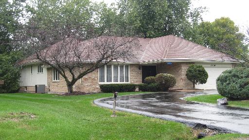 a front view of a house with garden and porch