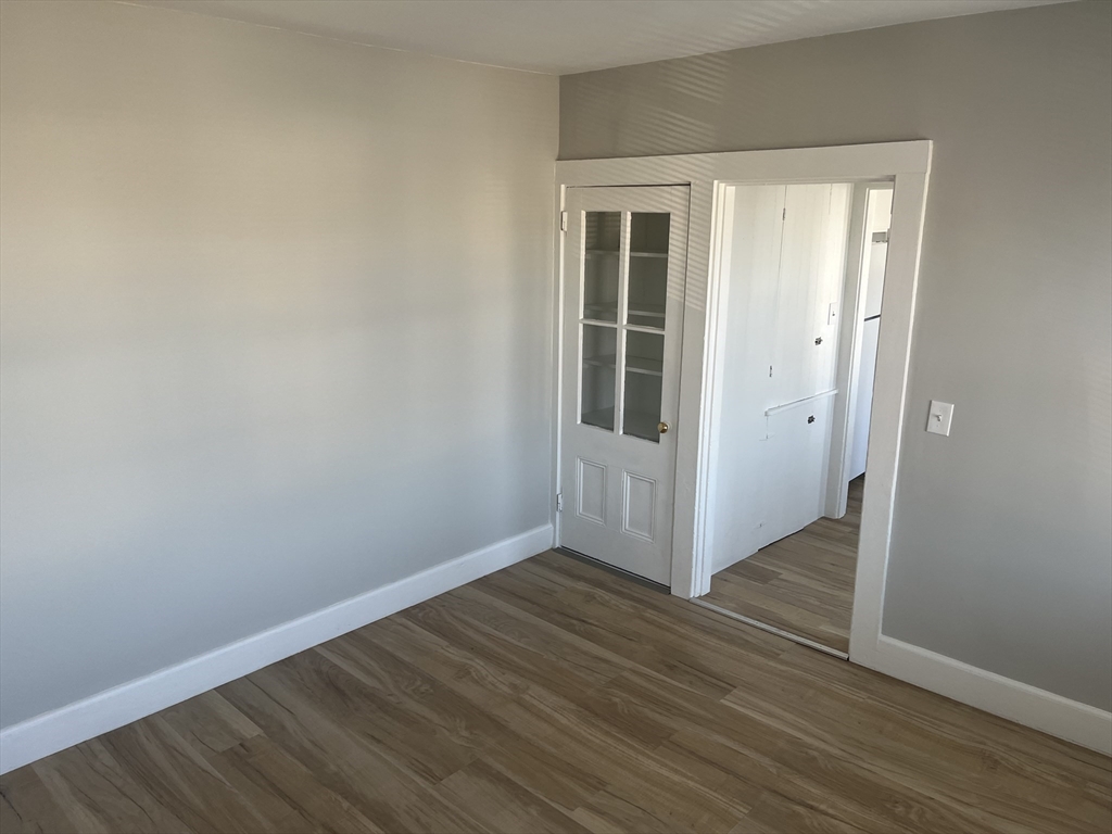 159 East Central Street, Unit 2 Franklin, MA 02038 - Photo 11 of 28 an empty room with wooden floor and a window