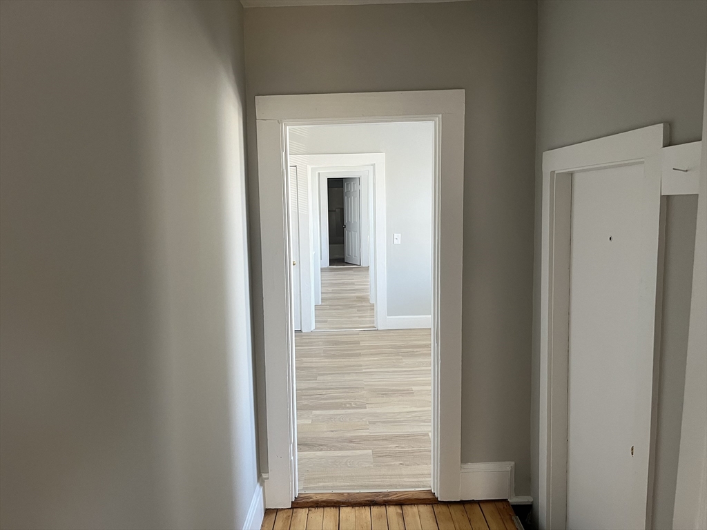 159 East Central Street, Unit 2 Franklin, MA 02038 - Photo 15 of 28 a view of a hallway with wooden floor and a door