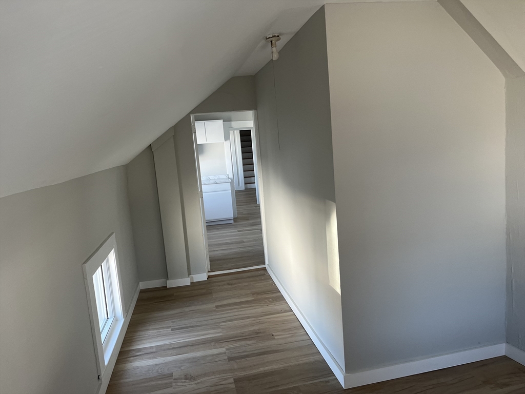 159 East Central Street, Unit 2 Franklin, MA 02038 - Photo 5 of 28 a view of a hallway with wooden floor and staircase