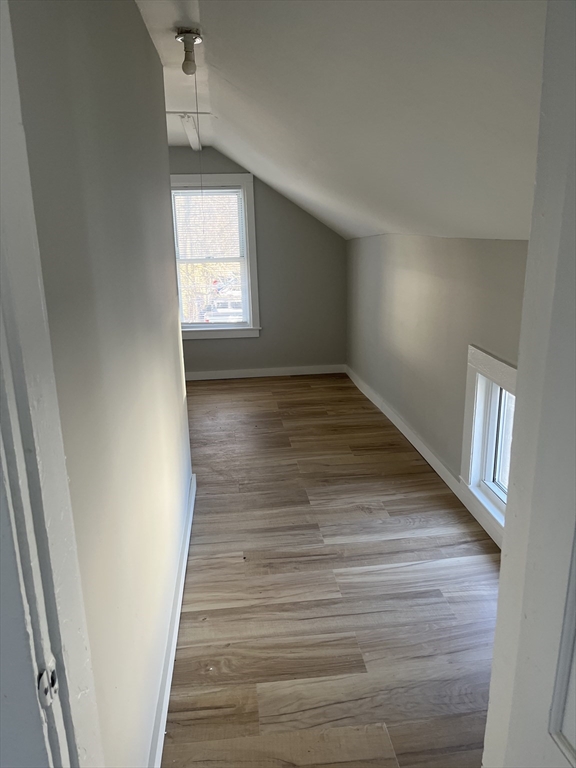 159 East Central Street, Unit 2 Franklin, MA 02038 - Photo 6 of 28 a view of an empty room with wooden floor and a window