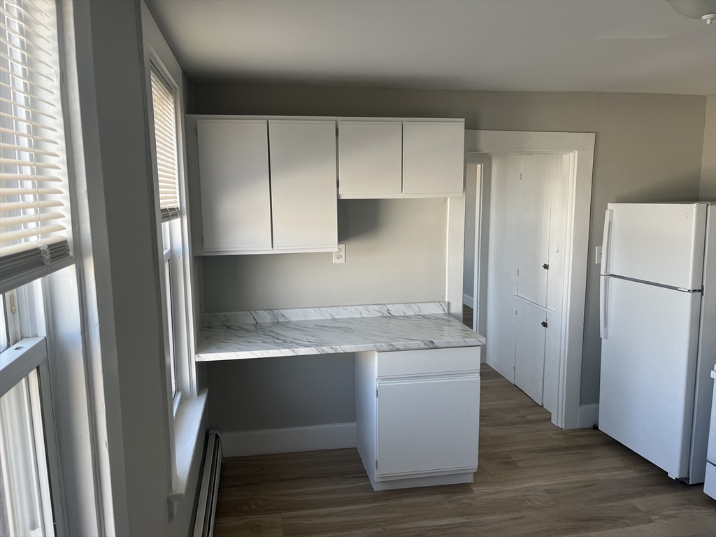 159 East Central Street, Unit 2 Franklin, MA 02038 - Photo 9 of 28 a kitchen with a sink and a refrigerator