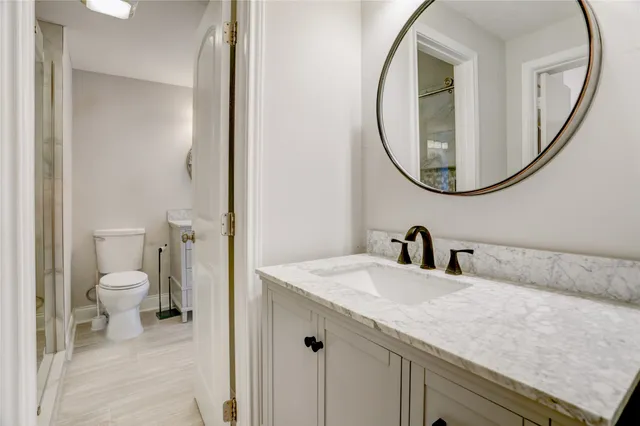 a backyard of a house with large trees and outdoor seating