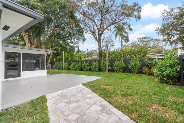 a view of a house with a backyard