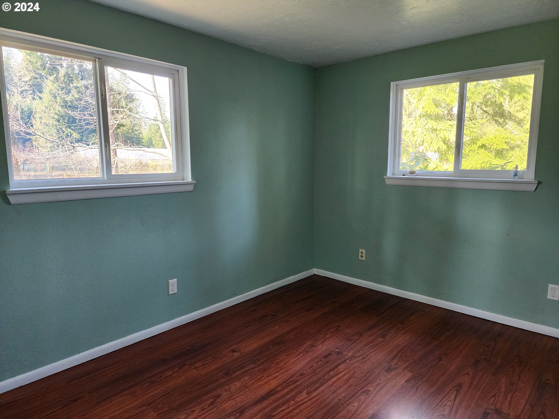 24361 South Upper Highland Road Colton, OR 97017 - Photo 6 of 47 an empty room with wooden floor and windows