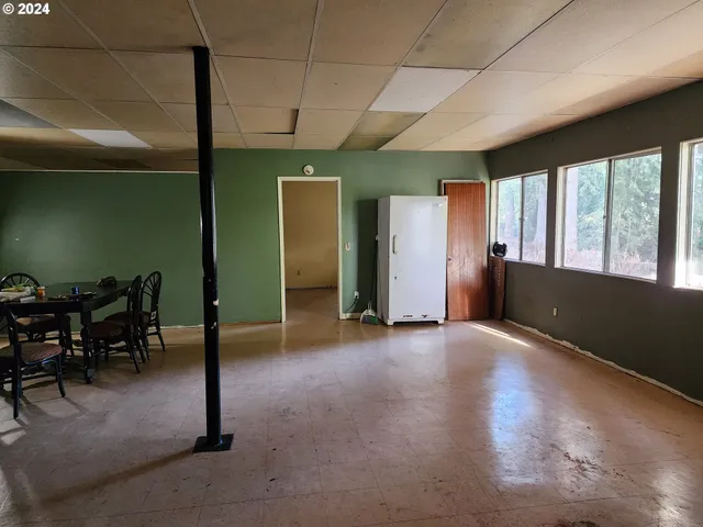 an empty room with furniture and windows