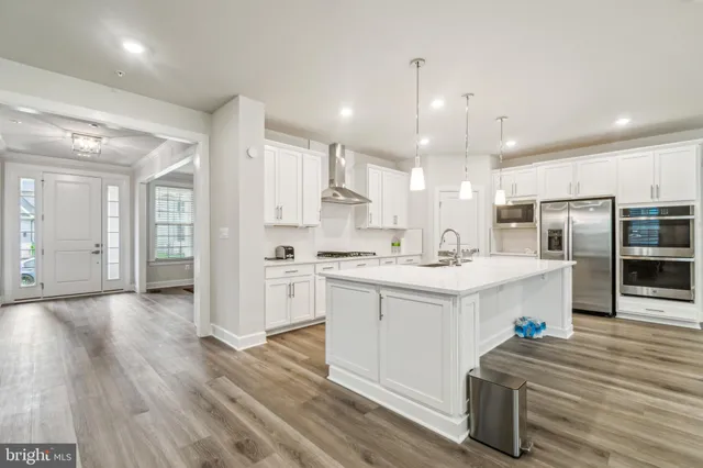 a kitchen with a sink stainless steel appliances and cabinets