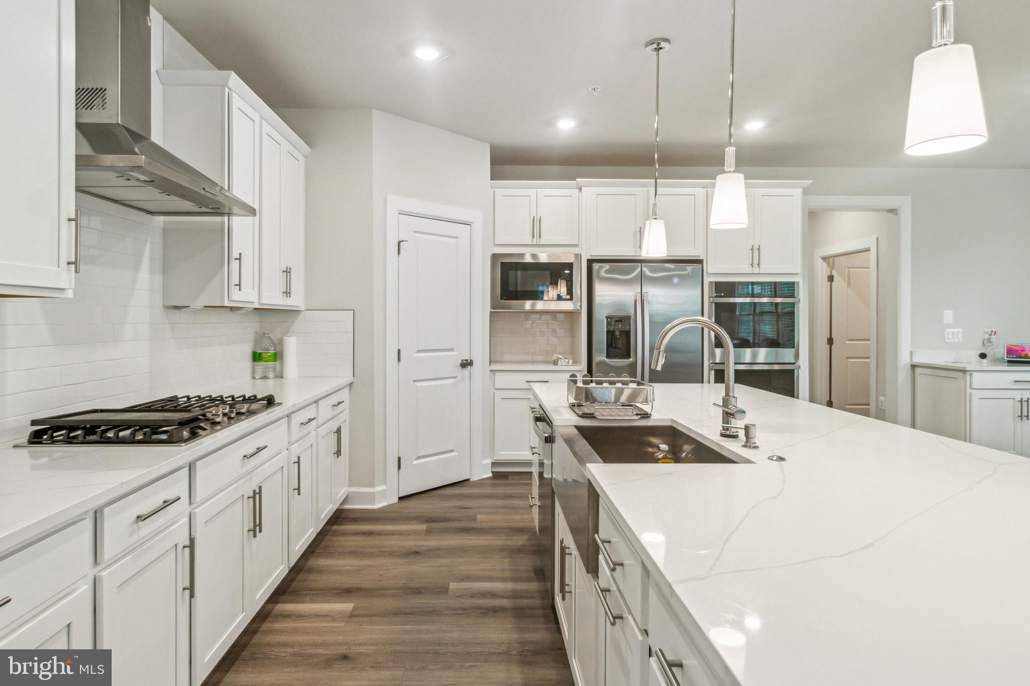 6536 Clubhouse Drive Laurel, MD 20708 - Photo 14 of 40 a kitchen with stainless steel appliances granite countertop a sink stove and refrigerator