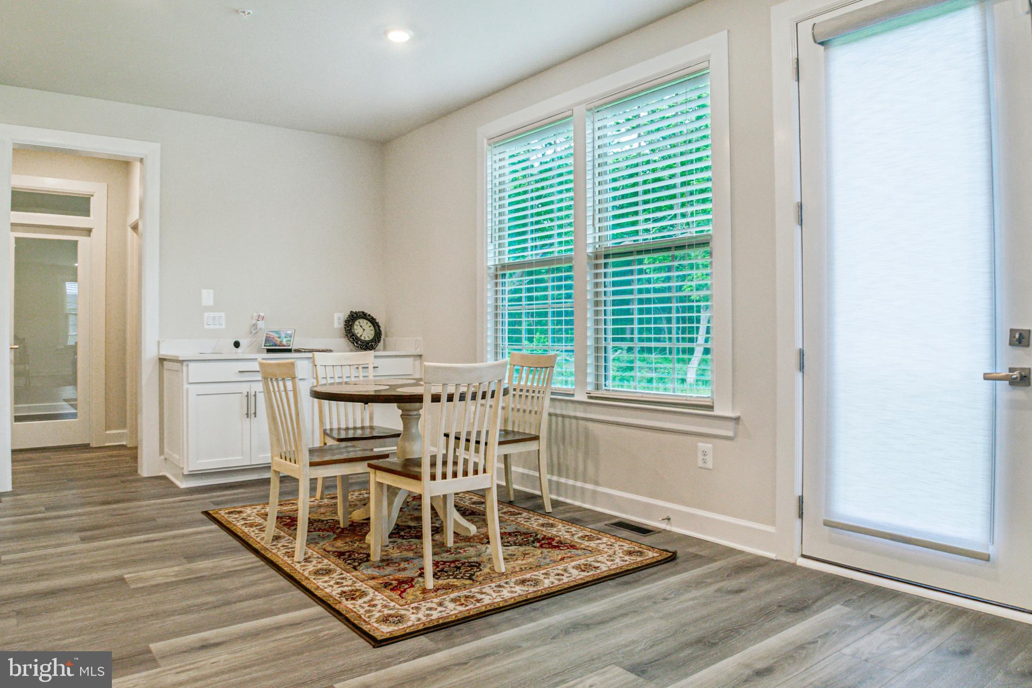 6536 Clubhouse Drive Laurel, MD 20708 - Photo 15 of 40 a view of a dining room with furniture and wooden floor