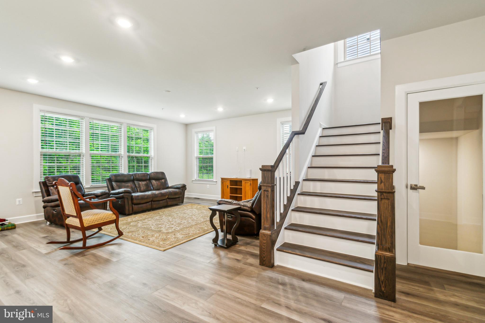 6536 Clubhouse Drive Laurel, MD 20708 - Photo 18 of 40 a living room with furniture and a wooden floor