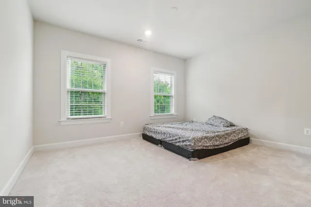 a living room with hard wood floor and window