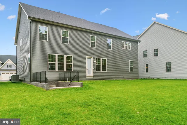 a view of a green field with wooden fence