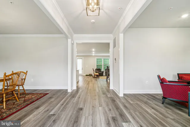 a view of dining room with furniture and wooden floor
