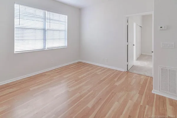 a view of an entryway with wooden floor