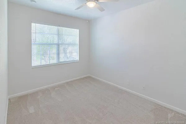 an aerial view of a house with a yard and lake view