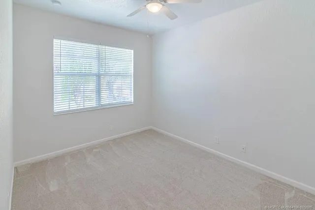 an aerial view of a house with a yard and lake view
